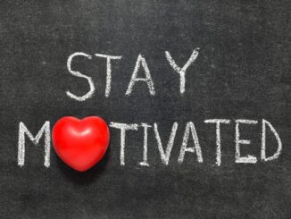 stay motivated phrase handwritten on blackboard with heart symbol instead of O