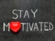 stay motivated phrase handwritten on blackboard with heart symbol instead of O